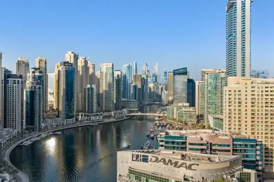 a view of a city with a river and buildings at Elegant One Bed Apartment - Panoramic Marina Views - Near JBR & Beach in Dubai
