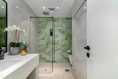 a bathroom with a shower with a glass door at Usmans 4 Bedroom Apartment on D Beach By SLS DIRECT BEACH ACCESS FULLY SERVICED JBR in Dubai
