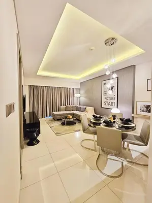 a living room with a couch and a table at 1BR Tower B Paramount Apartment in Dubai