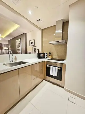 a large kitchen with a sink and a stove at 1BR Tower B Paramount Apartment in Dubai