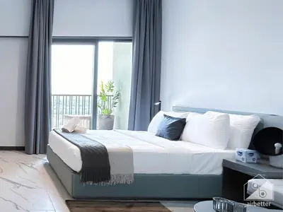 a bedroom with a large bed with a window at Modern Meydan Studio with Private Balcony in Dubai