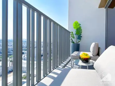a bedroom with a balcony with a view of a city at Modern Meydan Studio with Private Balcony in Dubai