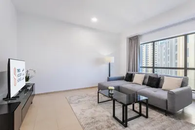 a living room with a couch and a large window at 2 Bedroom Apartment at Bahar 1 JBR by TSHH in Dubai