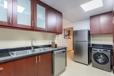 a kitchen with a sink and a dishwasher at 2 Bedroom Apartment at Bahar 1 JBR by TSHH in Dubai