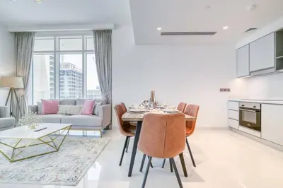 a living room with a table and a couch at New 2 bedroom full sea view in Dubai