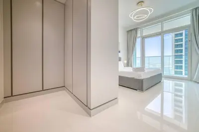 a bedroom with a bed and a large window at New 2 bedroom full sea view in Dubai