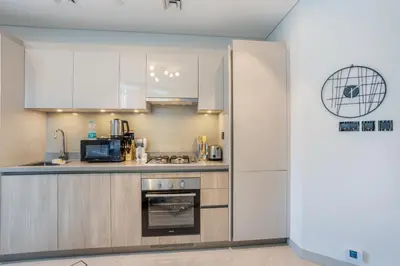 a kitchen with white cabinets and a stove at STAY BY LATINEM Luxury 2BR Holiday Home W205 near Burj Khalifa in Dubai