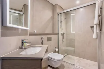 a bathroom with a sink and a toilet and a shower at STAY BY LATINEM Luxury 2BR Holiday Home W205 near Burj Khalifa in Dubai