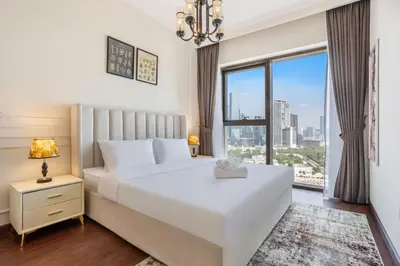 a bedroom with a large white bed and a window at Clse Elegance Redefined Luxury 1 Bedroom Apartment with Premium Facilities in Dubai
