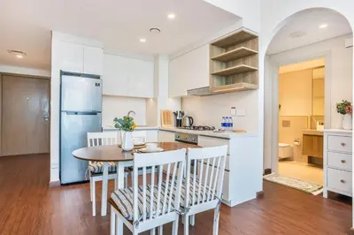 a kitchen and dining room with a table and chairs at Clse Elegance Redefined Luxury 1 Bedroom Apartment with Premium Facilities in Dubai