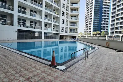 a swimming pool in the middle of a building at Vogue Al Fahad Tower, Al Barsha Heights near Mall of The Emirates, Walking Distance to DIC Metro Station, Two Bedroom Apartment with Balcony and Access to all Amenities in Dubai