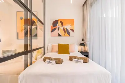 a bedroom with a bed with two pillows on it at Stylish Contemporary Home in JVC with Chic Interior in Dubai