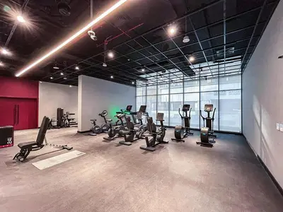 a gym with several treadmills and exercise bikes at Stylish Contemporary Home in JVC with Chic Interior in Dubai
