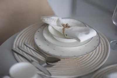 a plate with a napkin and a bowl with a flower on it at Modern and Cozy 1BR in Business Bay in Dubai
