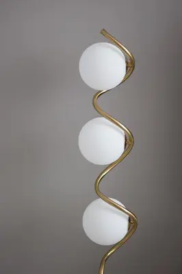 a metal wall light with a spiral design at Modern and Cozy 1BR in Business Bay in Dubai