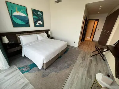 a bedroom with a large white bed in a room at Luxury 2BR Avani Palm View Apt in Dubai