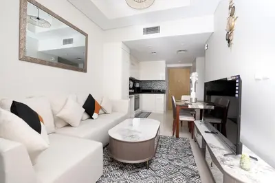a living room with a white couch and a table at Chic Aykon City 2-Bedroom Retreat - Business Bay in Dubai