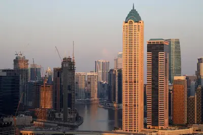 a city with tall buildings and a river at Chic Aykon City 2-Bedroom Retreat - Business Bay in Dubai