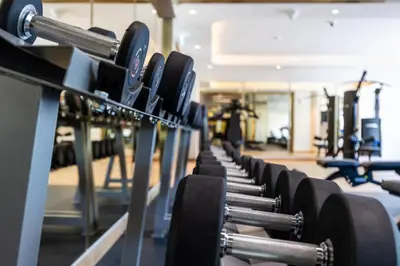 a row of dumbbells in a gym at Urban Oasis - Cosy Studio Retreat in Dubai