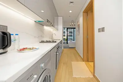 a kitchen with a sink and a dishwasher at Urban Oasis - Cosy Studio Retreat in Dubai