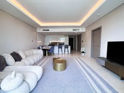 a living room with white couches and a tv at Chic 1-Bedroom in Sterling Tower, Downtown Stay - 17AB05 in Dubai