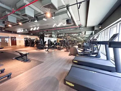 a gym with treadmills and exercise equipment in a building at Chic 1-Bedroom in Sterling Tower, Downtown Stay - 17AB05 in Dubai