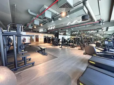 a gym with lots of treadmills and machines at Chic 1-Bedroom in Sterling Tower, Downtown Stay - 17AB05 in Dubai