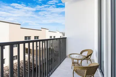 a balcony with two chairs and a table at Cozy & Bright Home in the Heart of JVC in Dubai