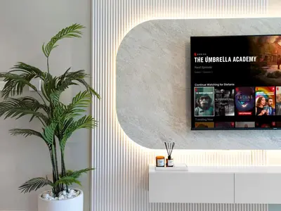 a potted plant in a living room with a mirror at Apartment in Downtown Dubai in Dubai