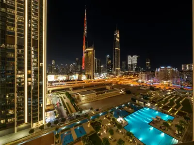 a view of a city at night with a pool at Apartment in Downtown Dubai in Dubai