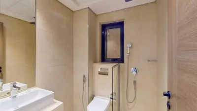 a bathroom with a shower and a sink and a mirror at Locations I Avanos Residence I Premium Modern 1BR I Cosy & Comfortable I Near Parks, Shops & Cafés in JVC in Dubai