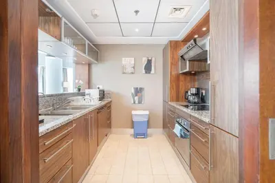 a large kitchen with wooden cabinets and a sink at 2 Bedroom Apartment full Marina View in Dubai