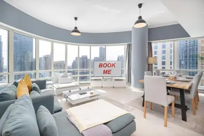 a living room with a blue couch and a table at 2 Bedroom Apartment full Marina View in Dubai