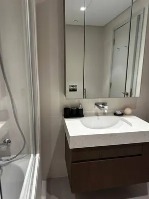 a bathroom with a sink and a mirror and a shower at BrandNew, OceanView, PrivateBeach, 1bed in Dubai