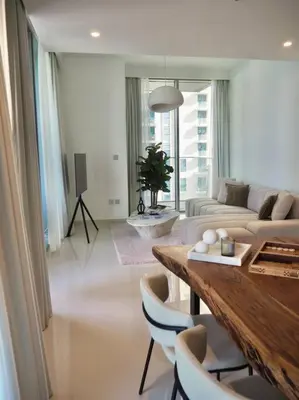 a living room with a table and a couch at BrandNew, OceanView, PrivateBeach, 1bed in Dubai