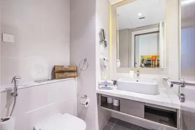a bathroom with a sink and a toilet and a mirror at Modern Home in Business Bay with Panoramic View in Dubai
