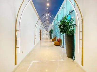 a hallway with arches and a potted plant at Modern Home in Business Bay with Panoramic View in Dubai