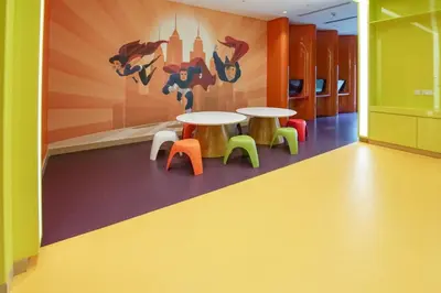 a room with two tables and colorful chairs at Modern Home in Business Bay with Panoramic View in Dubai