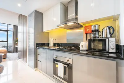 a kitchen with stainless steel cabinets and a microwave at Modern Home in Business Bay with Panoramic View in Dubai