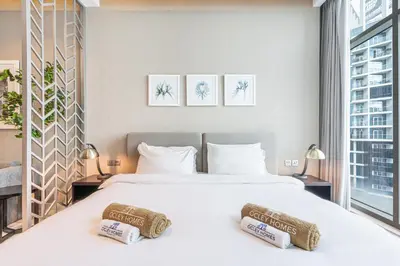 a bedroom with a large white bed with two pillows at Modern Home in Business Bay with Panoramic View in Dubai