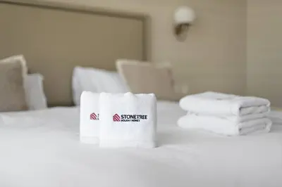 a pile of towels sitting on top of a bed at Stunning 1-BR Apartment In Heart Of The Palm in Dubai