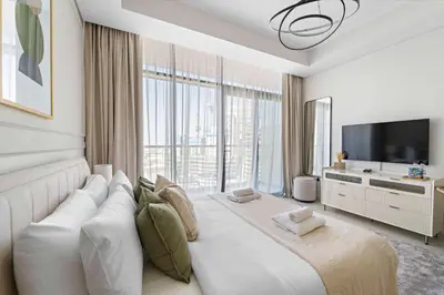 a hotel room with a large bed and a television at Silkhaus New Modern Studio In New Tower at Business Bay in Dubai
