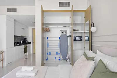 a living room with a bed and a kitchen at Silkhaus New Modern Studio In New Tower at Business Bay in Dubai