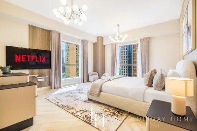 a bedroom with a king sized bed and a tv at LUX The Luxurious Central JBR Suite 2 in Dubai