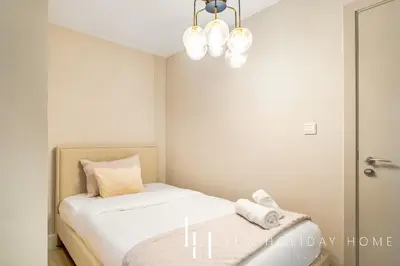 a small bedroom with a bed and a chandelier at LUX The Luxurious Central JBR Suite 2 in Dubai