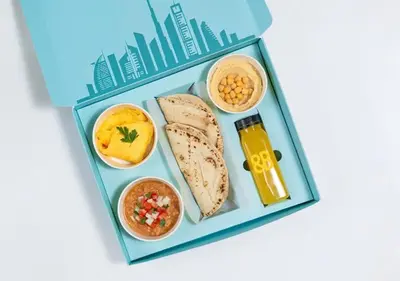 a bento box with a lunch of bread and food at Cosmos Living Sleek and Stylish GCV2 in Dubai