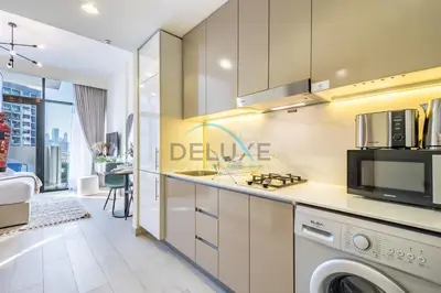 a kitchen with a washer and dryer at Calming Studio Apartment at Azizi Riviera 4, Al Merkadh by Deluxe Holiday Homes in Dubai