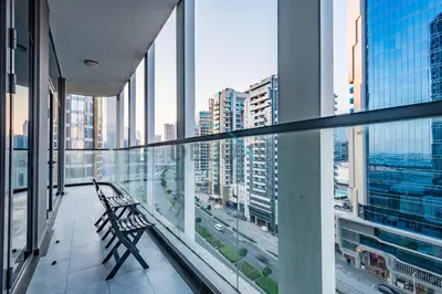 a bench in a building with a view of a city at Weekly Deal 3BR with Overlooking Canal & City Views by Deluxe Holiday Homes in Dubai