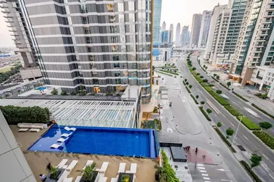 an overhead view of a city street with a swimming pool at Stunning 3BR Apartment in Bayz Tower, Business Bay by Deluxe Holiday Homes in Dubai
