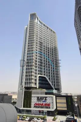 a large building with a sign in front of it at Stunning 3BR Apartment in Bayz Tower, Business Bay by Deluxe Holiday Homes in Dubai